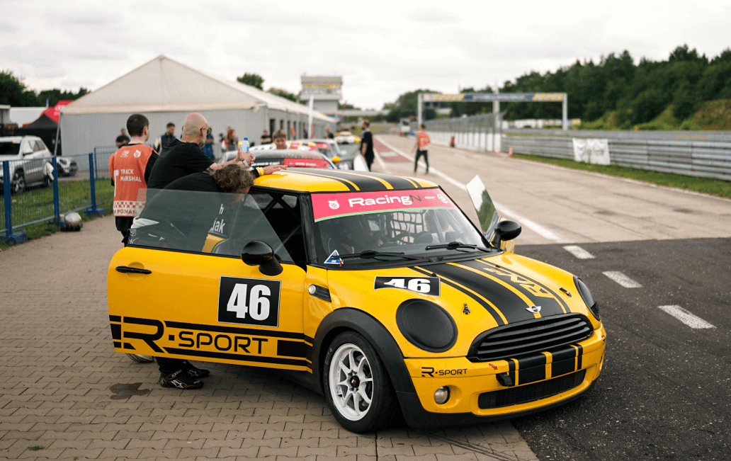 Trainer performing final safety check of driver before race start
