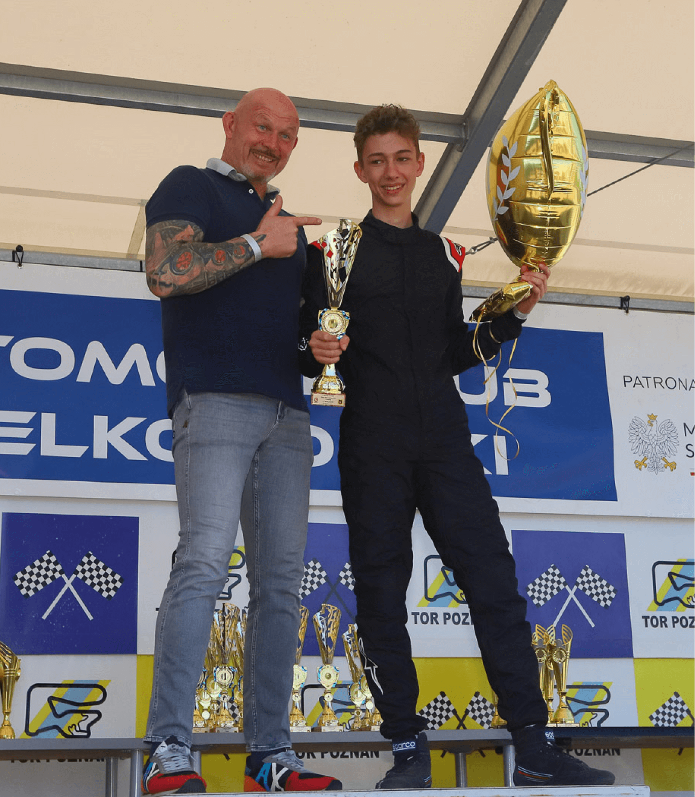 RSPORT CUP champion standing on podium after race victory