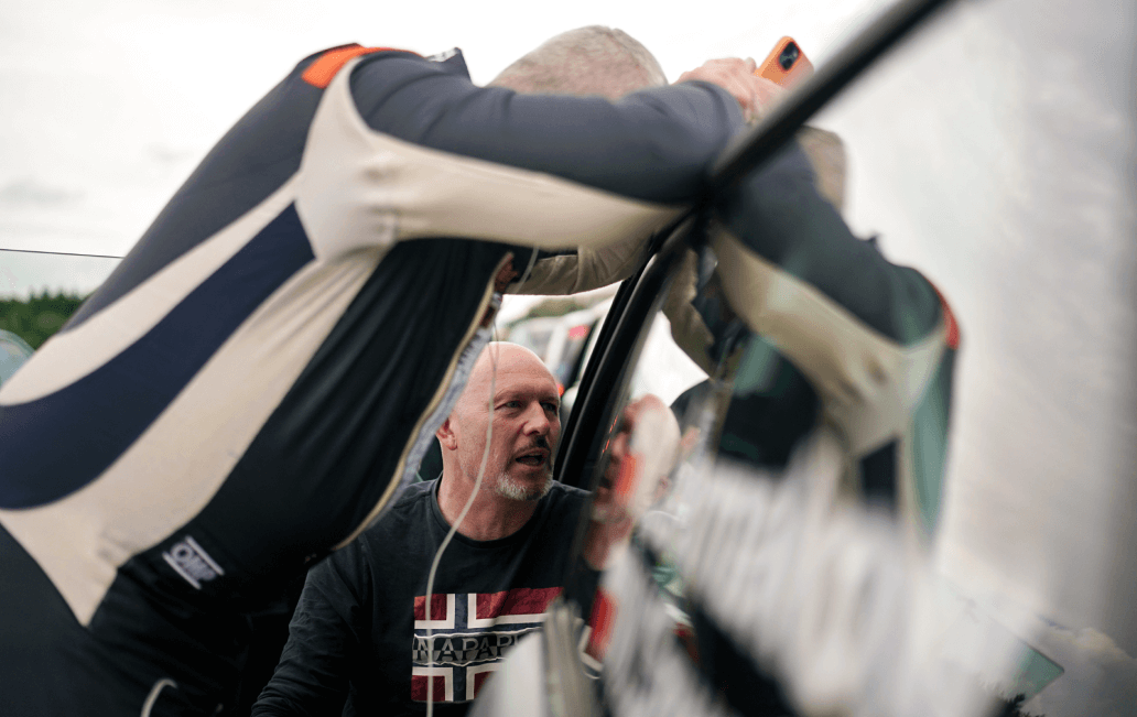 Trainer inspecting MINI race car before session